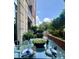 Inviting outdoor patio features a glass table with garden views at 1820 Peachtree St # 311, Atlanta, GA 30309
