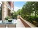 Inviting outdoor patio with a glass table, seating, and well-maintained landscaping, providing a tranquil escape at 1820 Peachtree St # 311, Atlanta, GA 30309