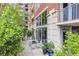 Serene patio featuring a glass table, chairs, and lush green landscaping, offering a peaceful outdoor retreat at 1820 Peachtree St # 311, Atlanta, GA 30309