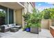 Relaxing patio with a cushioned sofa, coffee table, and views of greenery at 1820 Peachtree St # 311, Atlanta, GA 30309
