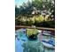 Cozy outdoor patio with glass table and seating, surrounded by lush greenery at 1820 Peachtree St # 311, Atlanta, GA 30309