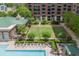 Community pool with outdoor seating and lounge chairs by a garden at 1820 Peachtree St # 311, Atlanta, GA 30309