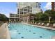 Relaxing pool area with ample seating, umbrellas, and a view of the surrounding upscale community at 1820 Peachtree St # 311, Atlanta, GA 30309