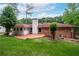 A view of the backyard showing the home, patio, stairs and chimney at 2655 Hayden Dr, East Point, GA 30344
