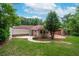 Spacious backyard with mature trees, a patio area, and plenty of green space for outdoor activities at 2655 Hayden Dr, East Point, GA 30344