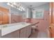 Bathroom featuring pink tile, a mirror, and a white vanity at 2655 Hayden Dr, East Point, GA 30344