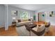 Bright living room with hardwood floors, neutral decor, and large windows showcasing the outdoor view at 2655 Hayden Dr, East Point, GA 30344