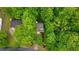 Aerial view of a home surrounded by lush green trees with a well manicured lawn, landscaping and long driveway at 3370 Ashton Dr, Suwanee, GA 30024