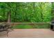 Spacious wooden deck perfect for outdoor dining, complete with a grill and views of the lush greenery at 3370 Ashton Dr, Suwanee, GA 30024