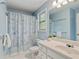 Bright bathroom with a patterned shower curtain and a single sink vanity at 3370 Ashton Dr, Suwanee, GA 30024