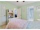 Bedroom with neutral walls, a doorway to a bathroom, and an additional door at 3370 Ashton Dr, Suwanee, GA 30024