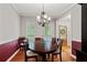 Formal dining room with wood floors, modern chandelier, and natural light at 3370 Ashton Dr, Suwanee, GA 30024