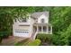 Charming two-story home with a well-manicured lawn, an attached garage, and a welcoming front porch at 3370 Ashton Dr, Suwanee, GA 30024