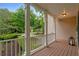 Charming front porch with white columns, wood flooring and a lantern, offering a picturesque view of the neighborhood at 3370 Ashton Dr, Suwanee, GA 30024