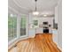 Eat-in kitchen with white cabinets, stainless steel appliances, and hardwood floors at 3370 Ashton Dr, Suwanee, GA 30024