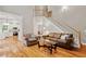 Open-concept living room with staircase and views into the kitchen at 3370 Ashton Dr, Suwanee, GA 30024