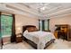 Comfortable main bedroom with tray ceiling, carpet, and natural light from large windows at 3370 Ashton Dr, Suwanee, GA 30024
