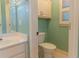 Small water closet includes a vanity, toilet and window at 1210 Lancelot Ct, Loganville, GA 30052