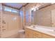 Full bathroom features a combination tub and shower and a double vanity at 1210 Lancelot Ct, Loganville, GA 30052
