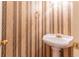 Traditional powder room with gold fixtures and striped wallpaper at 1210 Lancelot Ct, Loganville, GA 30052