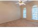 Spacious bedroom featuring two large windows and a ceiling fan at 1210 Lancelot Ct, Loganville, GA 30052