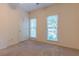 Bedroom with two windows and neutral walls at 1210 Lancelot Ct, Loganville, GA 30052