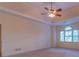 Bedroom featuring neutral carpet, a ceiling fan, and an arched window at 1210 Lancelot Ct, Loganville, GA 30052