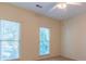 Bedroom with two windows and neutral walls at 1210 Lancelot Ct, Loganville, GA 30052
