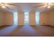 An expansive bonus room with dormers, carpet, and ceiling fans at 1210 Lancelot Ct, Loganville, GA 30052