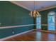 Elegant dining room features hardwood floors, a chandelier, two windows and stylish wall trim at 1210 Lancelot Ct, Loganville, GA 30052