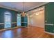 Elegant dining room features hardwood floors, a chandelier, two windows and stylish wall trim at 1210 Lancelot Ct, Loganville, GA 30052