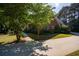 Exterior facade of home displaying a long driveway, brick exterior, and maintained lawn at 1210 Lancelot Ct, Loganville, GA 30052