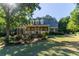 Charming home exterior with manicured lawn, mature trees, and inviting front porch at 1210 Lancelot Ct, Loganville, GA 30052