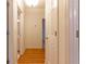 Hallway with hardwood floors leads to other rooms at 1210 Lancelot Ct, Loganville, GA 30052