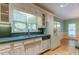 Kitchen features white cabinets, stainless steel sink, and verdant countertops at 1210 Lancelot Ct, Loganville, GA 30052