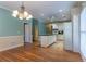 Eat-in kitchen with white cabinets, island, and natural lighting from windows at 1210 Lancelot Ct, Loganville, GA 30052