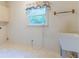 Bright laundry room with a utility sink and a window view at 1210 Lancelot Ct, Loganville, GA 30052