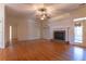 Spacious living room with hardwood floors, ceiling fan, and brick fireplace at 1210 Lancelot Ct, Loganville, GA 30052