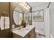 Stylish bathroom with a wood vanity, double sinks, and a shower-tub combo at 2608 Barge Sw Rd, Atlanta, GA 30331
