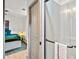 Modern bathroom features a glass shower with neutral toned large tiles, towel bar, and view to the bedroom at 2608 Barge Sw Rd, Atlanta, GA 30331