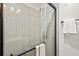 Modern bathroom features a glass shower with neutral toned large tiles and a towel bar at 2608 Barge Sw Rd, Atlanta, GA 30331