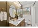 Stylish bathroom featuring double vanity, marble countertops, and modern fixtures at 2608 Barge Sw Rd, Atlanta, GA 30331
