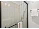 Modern bathroom features a glass-enclosed shower with gray tile surround and matte black hardware at 2608 Barge Sw Rd, Atlanta, GA 30331
