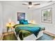 Cozy bedroom with a ceiling fan, hardwood floors, lots of natural light, and decorated side tables at 2608 Barge Sw Rd, Atlanta, GA 30331