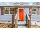 Charming home featuring an orange front door, window shutters, and an inviting front porch at 2608 Barge Sw Rd, Atlanta, GA 30331