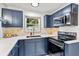 Updated kitchen featuring modern appliances, custom cabinetry and tile backsplash with a bright window at 2608 Barge Sw Rd, Atlanta, GA 30331