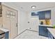 Charming kitchenette features custom blue cabinetry, white countertops, and modern tile flooring at 2608 Barge Sw Rd, Atlanta, GA 30331