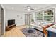 Sun-filled living room with modern décor, wood flooring, and large windows at 2608 Barge Sw Rd, Atlanta, GA 30331