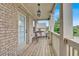 Inviting covered back porch with a charming wicker bench, perfect for relaxation and outdoor enjoyment at 412 Live Oak Pass, Loganville, GA 30052
