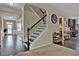 Entryway features a wooden staircase and access to the kitchen and entryway at 412 Live Oak Pass, Loganville, GA 30052